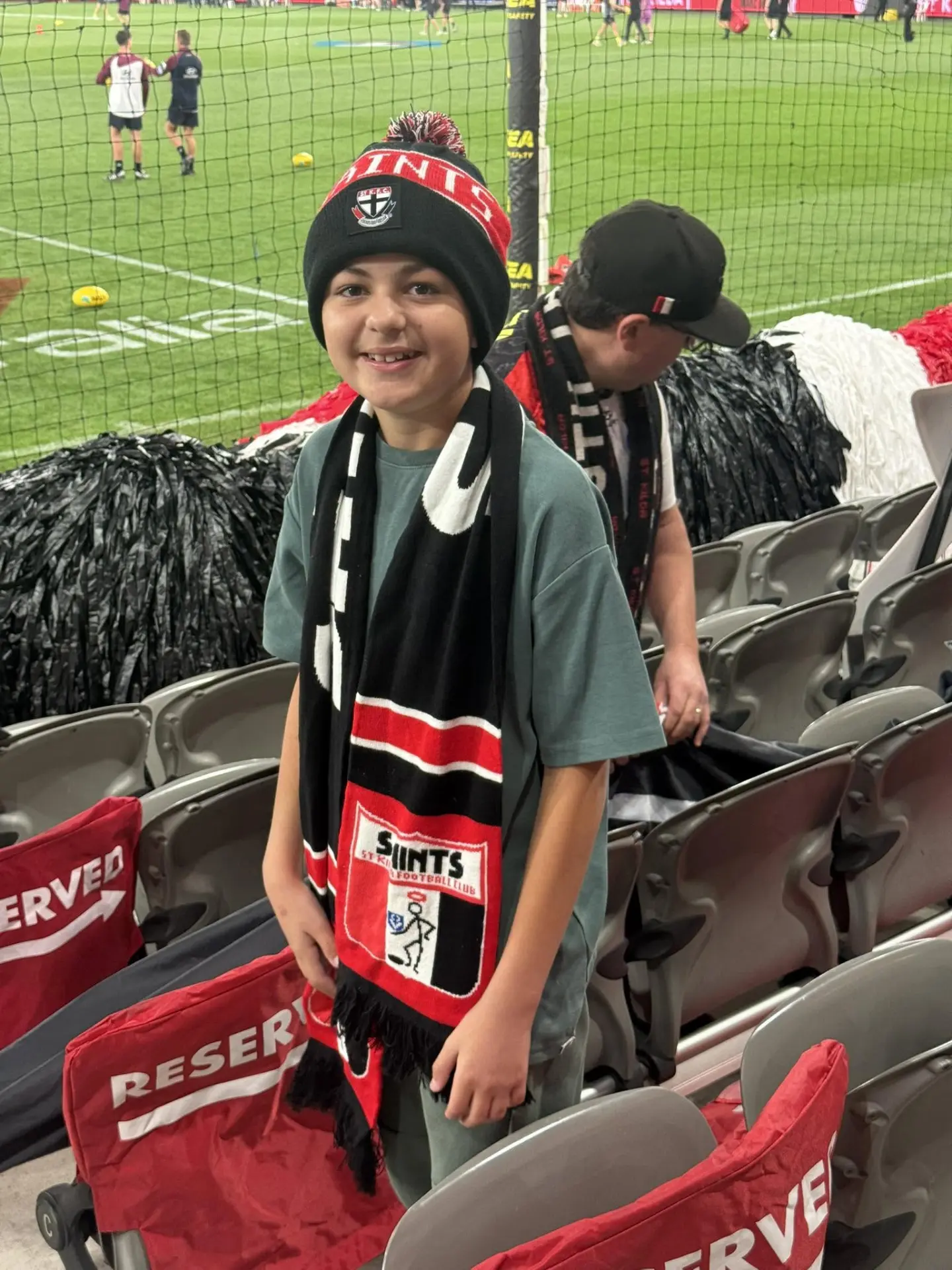 Oliver at the footy in his supporter gear